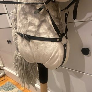gray hobby horse and figure 8 bridle and martingale